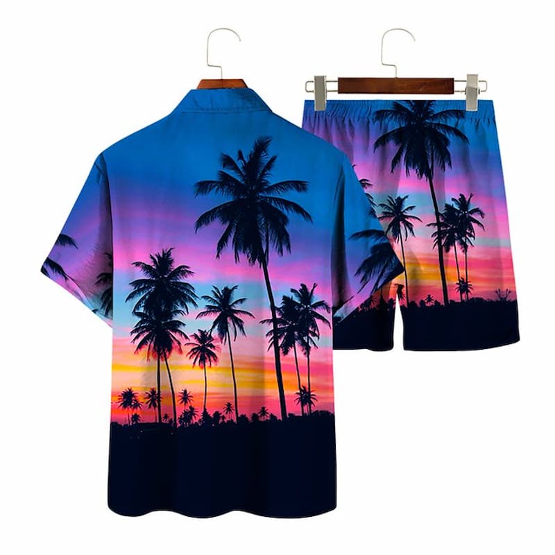 A two-piece men's casual set featuring a short-sleeve button-up shirt and matching shorts, both printed with a tropical sunset scene of palm tree silhouettes against a blue, pink, and orange sky. The set is displayed on wooden hangers against a plain white background.
